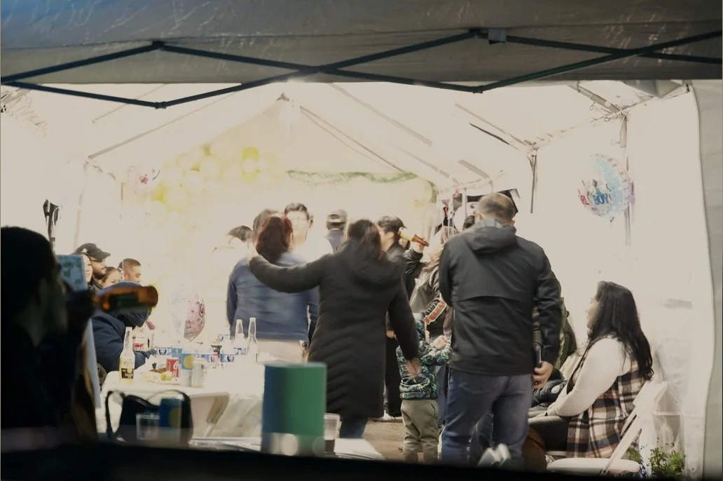 Guests celebrating together under the event tent