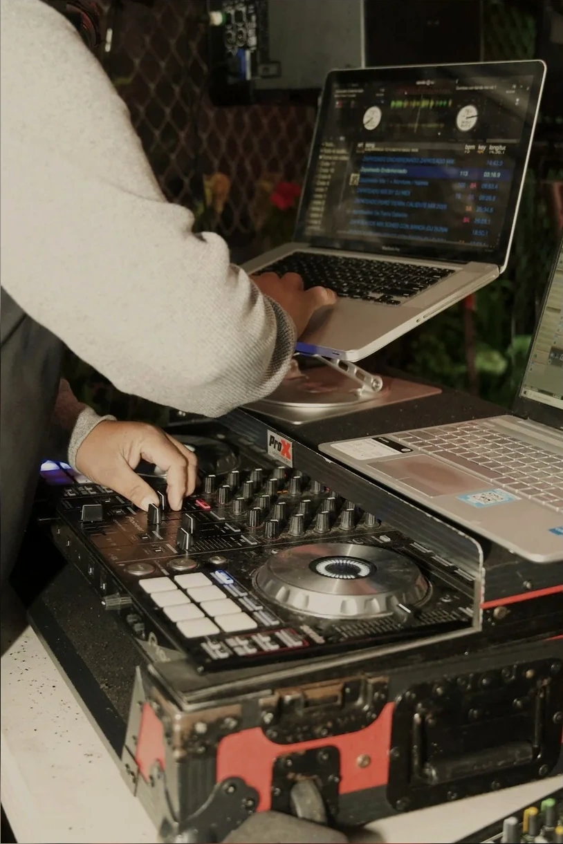 DJ Junny mixing music on the controller