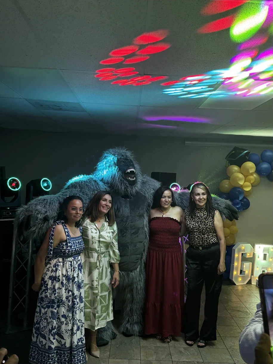 Gorilla Mascot posing with guests at a celebration